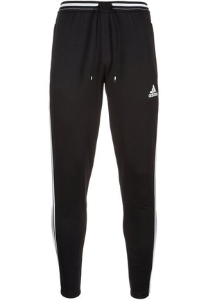 Pantalon de sport noir Adidas avec des bandes blanches sur les côtés, taille à cordon et logo Adidas sur la partie supérieure de la cuisse gauche.
