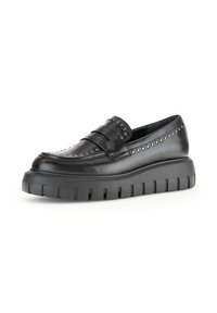 Zwarte leren instapschoenen met decoratieve studs, voorzien van een dikke, profielzool en een zachte buitenkant voor extra comfort.