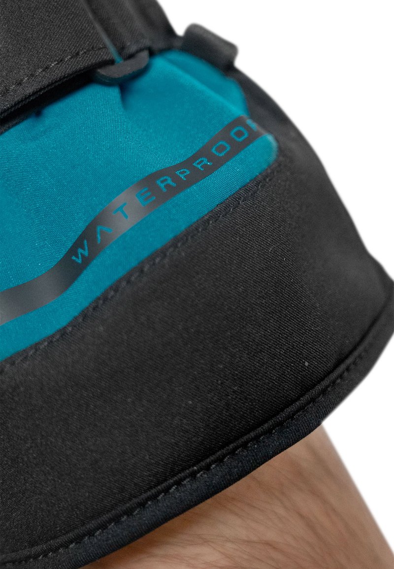 Waterproof leg strap features a solid black base with a vibrant blue upper section, displaying the word "WATERPROOF" in sleek black font.