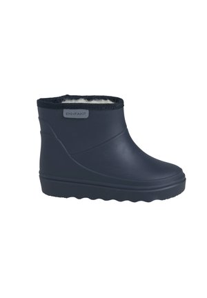 Navy blue waterproof ankle boot with soft fleece lining and a label tag on the side, designed for cold and wet weather.