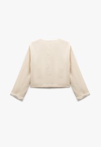 Beige kort jacka med långa ärmar och uppvikta manschetter, liggande på en vit bakgrund som visar baksidan.