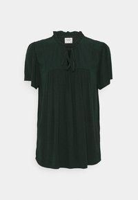 Blusa corta a maniche corte verde scuro con colletto arricciato, dettaglio a nastro sul collo e motivo a pois discreto. Vestibilità leggermente ampia con dettagli arricciati.