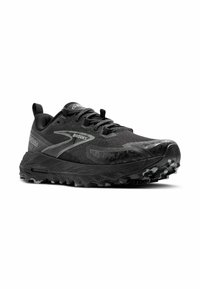 Zapatilla de trail running negra con una parte superior de malla texturizada, detalles reflectantes y una suela de goma rugosa con tacos profundos para mayor tracción.