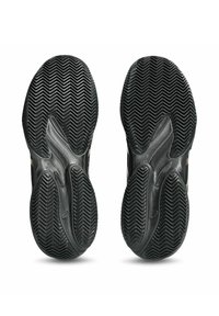 Scarpe sportive nere con suola in gomma caratterizzata da un motivo a zigzag, design curvo e superficie liscia. Senza loghi o dettagli visibili.