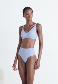 Set de bralette și lenjerie înaltă de culoare albastru deschis, fără cusături. Material moale, textură netedă, design minimalist fără mărimi.