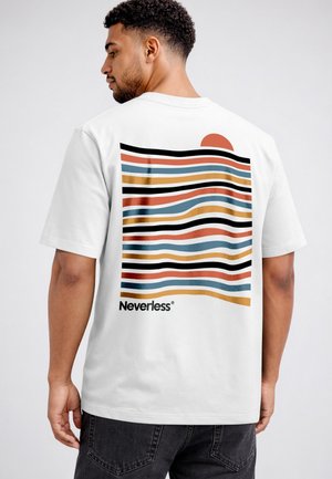 Man wearing a white t-shirt with wavy colored stripes, a half sun graphic, and the word "Neverless" on the back, seen from behind.