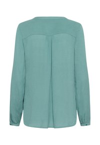 Long-sleeve shirt in soft teal fabric, featuring a subtle sheen, a yoke detail at the back, and buttoned cuffs. Simple, straight cut.