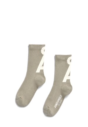 Khaki ribbed socks with white logo 'A' on the side and branding at the toe. Soft texture and mid-calf length design.