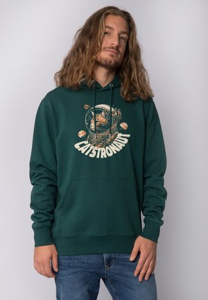 Hoodie vert foncé avec un graphique frontal d'un chat dans un casque d'astronaute, présentant des planètes et des étoiles. Il est doté d'une poche kangourou et de cordons de serrage.