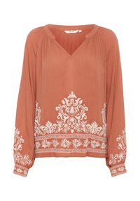 Rostfarbige Bluse mit V-Ausschnitt, langen Ärmeln und weißer Blumenstickerei am unteren Rand und an den Ärmeln. Leichtes, strukturiertes Material.
