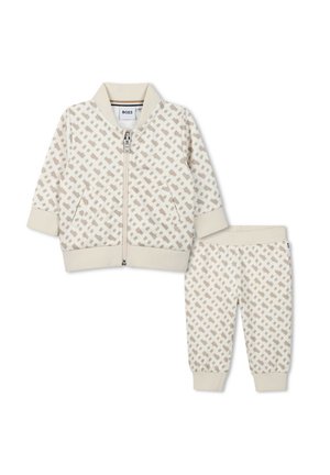 Ensemble beige à deux pièces comprenant une veste bomber zippée et un pantalon assorti. Présente un motif géométrique marron clair. Tissu doux, poignets et taille côtelés.