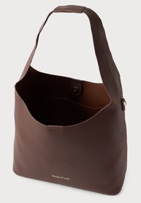Brown leather shoulder bag with a smooth texture, a wide opening, and a gold logo at the front. Features a single strap for carrying.