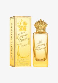 Perfumy Juicy Couture "It's Sunny Hunny" w przezroczystej butelce z złotą nakrętką w kształcie korony, obok dekoracyjnego żółtego pudełka z napisem.
