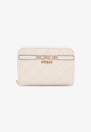 Quilted beige wallet with a glossy finish, featuring a zip closure and a metallic accent engraved with "GUESS." Diamond pattern visible.