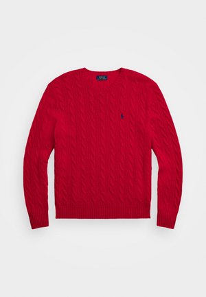 Red cable-knit sweater with a crew neckline, ribbed cuffs and hem, featuring a small navy logo on the chest. Made from a soft fabric.