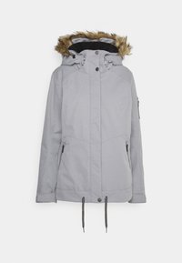 Veste d’hiver gris clair avec capuche bordée de fourrure, fermeture éclair devant, boutons-pression, poches latérales zippées et cordons de serrage ajustables à l’ourlet.