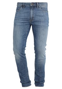 Denim jeans in a medium blue wash with a slim fit. Features include a five-pocket design, button front, and subtle fading.