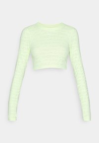 Long-sleeve cropped athletic top in light green with a textured pattern of "Nike Pro" branding throughout. Smooth, stretchy fabric.