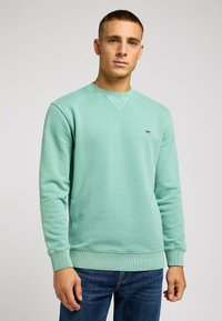 Miętowa bluza z bawełnianej mieszanki, okrągły dekolt, ściągacze na rękawach i dolnej krawędzi, z małym czarnym logo "Lee" na klatce piersiowej.