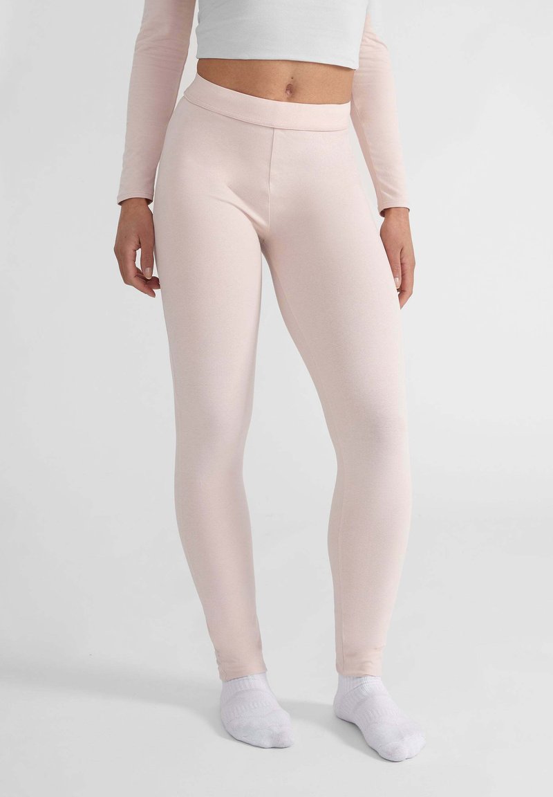 Leggings rosa chiaro realizzati in tessuto elasticizzato, con vita alta e una texture liscia. Lunghezza alla caviglia senza cuciture o motivi visibili.