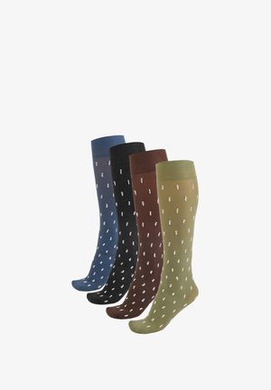 Quattro paia di calze fino al ginocchio in blu, nero, marrone e verde. Ognuna presenta un motivo a pois bianchi e una trama liscia.