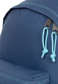 Blauer Stoffrucksack mit kontrastierenden hellblauen Akzenten, mit strukturierter Oberfläche, Kordelzugverschluss und sichtbaren Nahtdetails.