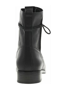 Botte cheville en cuir noir avec une texture lisse, un talon fin et un panneau décoratif à l'arrière avec un système de fermeture à lacets. Design minimaliste.