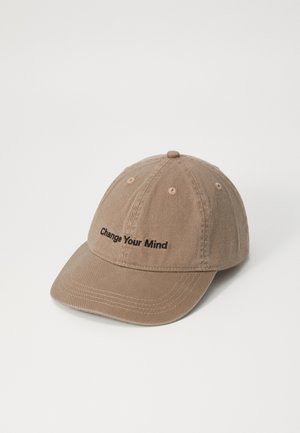 Brown cotton baseball cap with a curved visor, featuring embroidered text "Change Your Mind" in black. Six ventilation holes on the crown.
