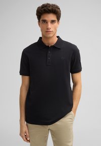 Schwarzes Polohemd aus glattem Stoff, mit klassischem Kragen, dreiknopfiger Knopfleiste und gesticktem Logo auf der Brust.