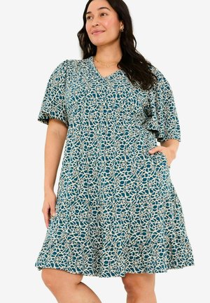 Kurzärmliges Kleid in Teal mit einem weißen Blumenmuster. Es hat einen V-Ausschnitt, eine geraffte Taille und Taschen. Ausgestellter Rock bis zum Knie.