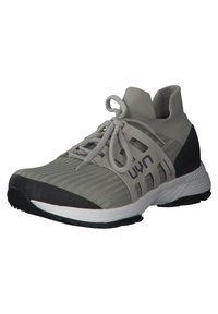 Light grey athletic shoe with knit fabric, elastic collar, prominent lateral branding, black accents, and a textured rubber sole.
