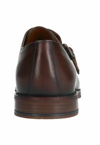 Brown leather shoe with a sleek design, rounded toe, and a low wooden heel, featuring a smooth texture and minimal hardware accents.