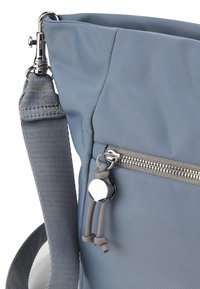 Borsa in nylon grigia con tracolla testurizzata, dotata di una tasca con zip e accenti in metallo. Superficie liscia con un design elegante.