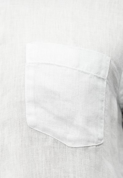 Λευκό λινό πουκάμισο με μία τσέπη στο στήθος, υφή υφάσματος και απλό, ανεπιτήδευτο σχέδιο με καθαρές γραμμές.