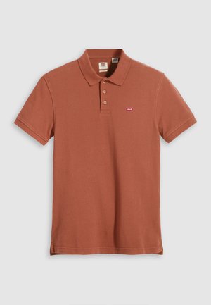 Brown polo shirt with a soft texture, three-button placket, and a small red Levi's logo on the left chest. Short sleeves and a classic design.