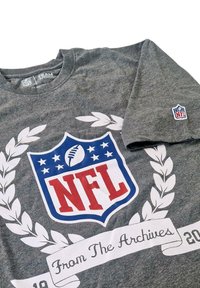Gray cotton t-shirt featuring a large NFL logo in red and blue, surrounded by white laurel leaves and a banner stating "From The Archives."