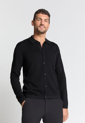 Black knit cardigan with a collared neck, front button closure, long sleeves, and smooth texture. Fitted design with a classic silhouette.
