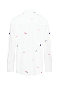 Fehér, hosszú ujjú ing, amelyen apró, hímzett rózsaszín, piros, tengerészkék és fekete szívek, virágok, csillagok és a "oui" szó található elszórtan a szöveten.