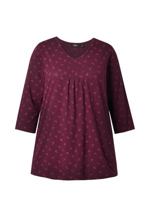 Maroon top met een V-hals en driekwartmouwen, met een plooidetail en een klein, contrasterend patroon erdoorheen. Zachte, vloeiende stof.