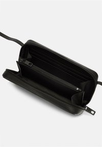 Schwarze Lederbörse mit einem Reißverschluss. Das Innere verfügt über Kartenfächer und ein Reißverschlussfach. Texturierte Oberfläche und schlankes Design.