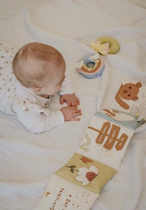 Puha, steppelt szövetszőnyeg pasztell színekkel, állatmotívumokkal és betűs csíkokkal. Tartalmaz texturált elemeket és különféle aranyos mintákat.