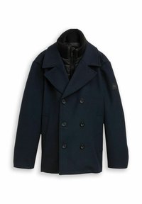 Cappotto doppiopetto blu navy realizzato in tessuto testurizzato, dotato di un colletto alto, fodera interna nera e bottoni neri.
