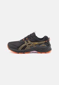 Black athletic shoes with a textured mesh upper, featuring orange accents and a cushioned sole. Designed for durability and comfort.