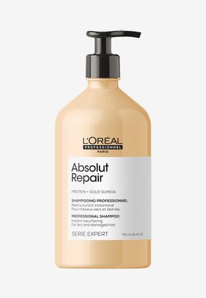 750 ml flaske L’Oréal Absolut Repair shampoo; semi-ugennemsigtig ferskenfarvet plast, sort pumpe, hvid etiket med sort tekst og professionel branding.