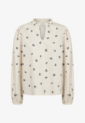 Hele kreemjasest bluus, mis on valmistatud tekstureeritud kangast, millel on võtmeauku kaelus, pikad varrukad ja hajutatud tumesinised lillemustrid. Rikkalik krae detail.