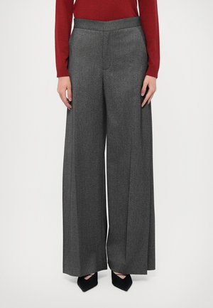 Wide-leg gray trousers with a textured fabric, pleated front, and a high waistband. Paired with black pointed-toe heels.
