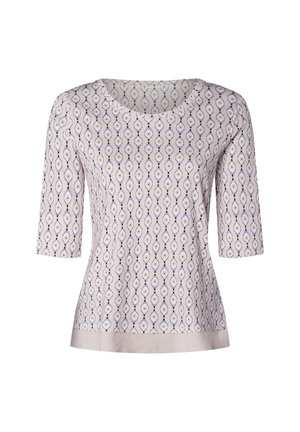 Helllila Bluse mit symmetrischem Augenmuster in Marineblau und Weiß. Mit Rundhalsausschnitt und drei Viertelärmeln, satinartigem Saum.