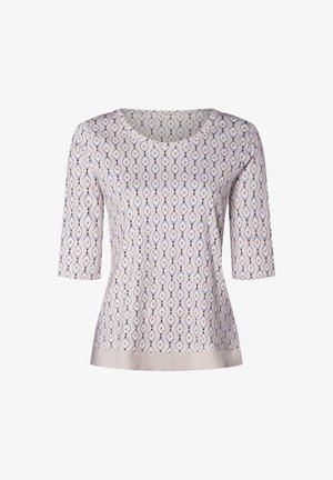 Light purple blouse with a symmetrical eye pattern in navy and white. Features a round neckline and three-quarter sleeves, satin-like bottom hem.