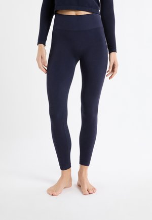 Marineblauwe legging met een hoge tailleband, zachte stof en een aansluitend ontwerp. Gladde textuur zonder zichtbare patronen of hardware-details.