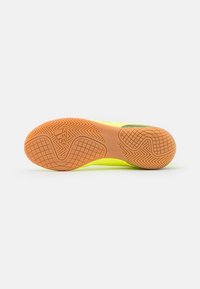 Sport shoe featuring a textured, bright yellow upper and a rubber orange sole with a detailed grip pattern and Adidas logo.